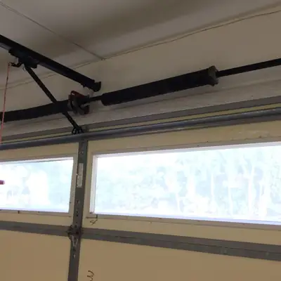 Torsion bar and springs above a door with window panels