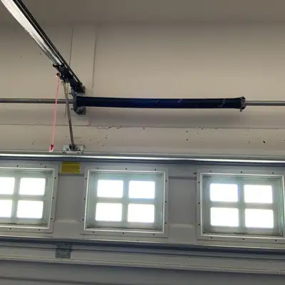 Torsion spring above a door with windows
